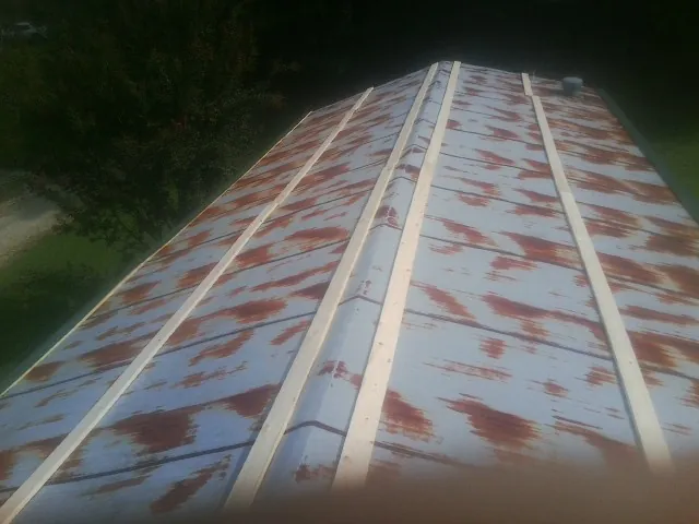 Rusted metal roof panels with new wood purlins before replacement — Storm Damage Roof Repair in Erlanger by Roofing Brothers