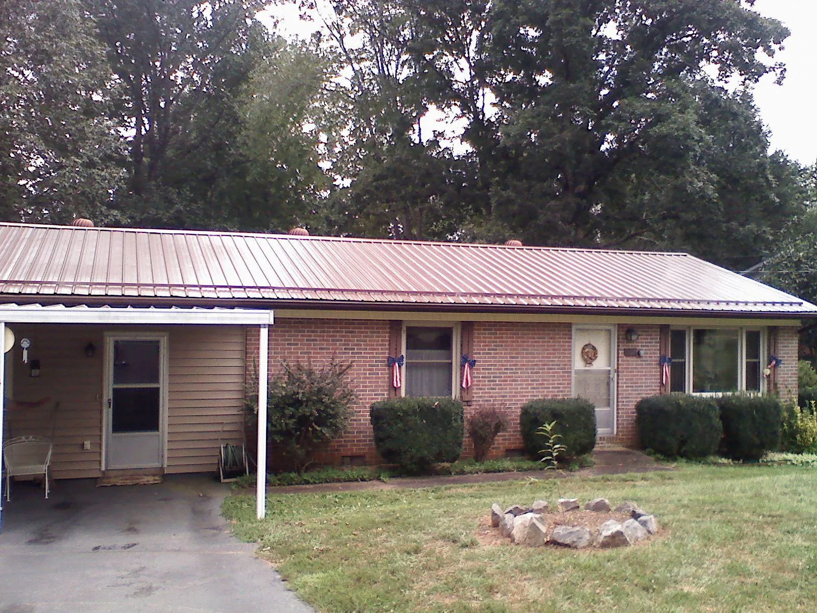 Bronze metal roof and carport on a brick ranch home — Roof Repair work by our crew in Erlanger