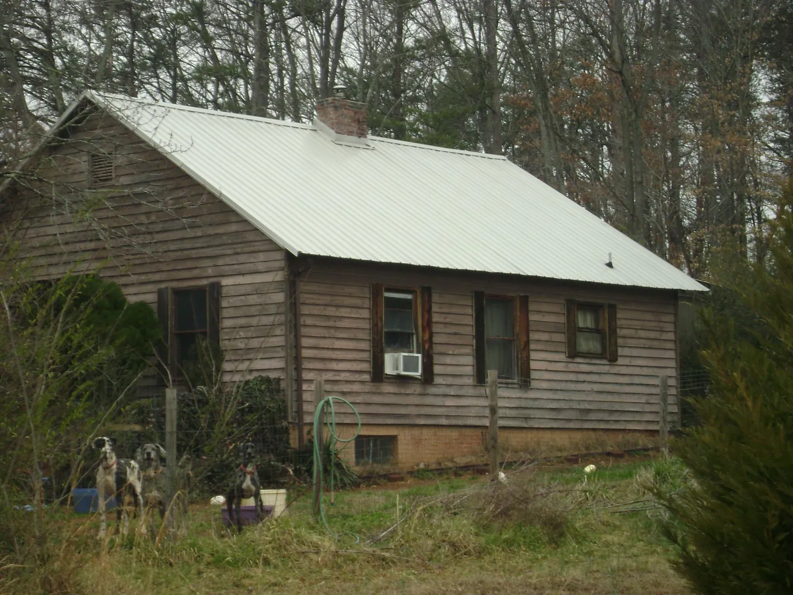 White metal roof on an old wood sided farmhouse, from a Metal Roof Installation job in Erlanger